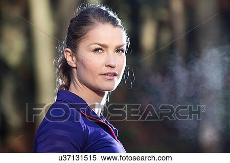Portrait of young woman looking at camera, condensation from breath View Large Photo Image Stock Photography - Portrait of young woman looking at camera, condensation from breath. Fotosearch