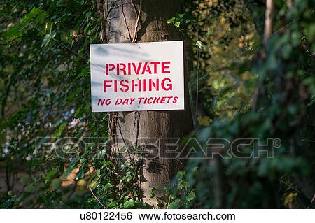 Stock Photograph - Private fishing notice on woodland tree. Fotosearch