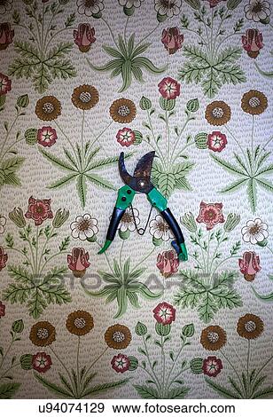 Stock Photo - Pruner on floral-patterned background. Fotosearch