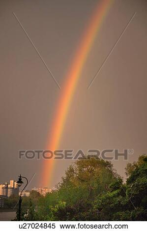 Stock Photography - Rainbow over city. Fotosearch