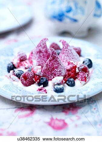 Stock Photography - Raspberry meringue dessert with blueberries. Fotosearch