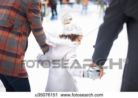 Rear view of girl ice skating with parents, holding hands View Large Photo Image Stock Image - Rear view of girl ice skating with parents, holding hands. Fotosearch