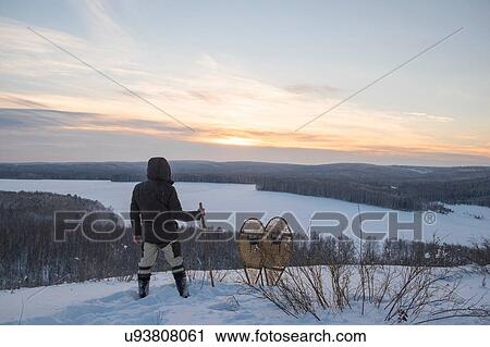 Rear view of male hiker looking out over snow covered landscape, Ural, Russia View Large Photo Image Stock Image - Rear view of male hiker looking out over snow covered landscape, Ural, Russia. Fotosearch