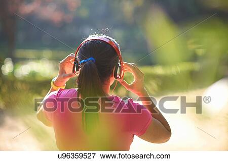 Rear view of mature woman with pony tail wearing headphones View Large Photo Image Stock Photo - Rear view of mature woman with pony tail wearing headphones. Fotosearch