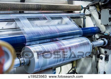 Stock Image - Rolls of printed plastic film in food packaging printing factory. Fotosearch