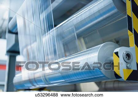 Rolls of printed plastic film in food packaging printing factory View Large Photo Image Stock Photo - Rolls of printed plastic film in food packaging printing factory. Fotosearch