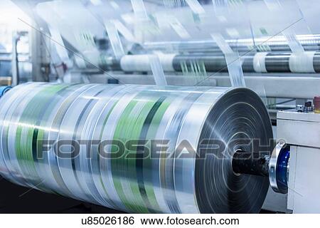 Stock Photograph - Rolls of printed plastic film in food packaging printing factory. Fotosearch