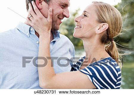 Romantic couple face to face in park View Large Photo Image Stock Image - Romantic couple face to face in park. Fotosearch