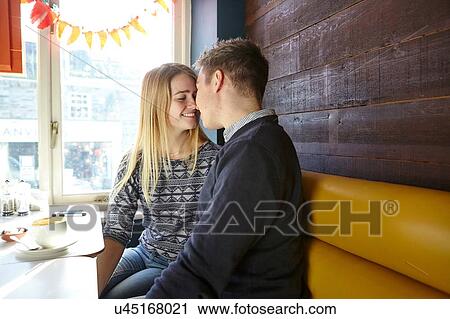 Romantic young couple face to face in cafe window seat View Large Photo Image Stock Image - Romantic young couple face to face in cafe window seat. Fotosearch