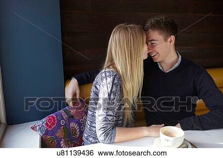 Romantic young couple face to face in cafe View Large Photo Image Stock Photograph - Romantic young couple face to face in cafe. Fotosearch