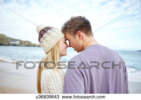Romantic young couple face to face on beach, Constantine Bay, Cornwall, UK View Large Photo Image Stock Image - Romantic young couple face to face on beach, Constantine Bay, Cornwall, UK. Fotosearch