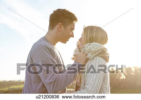 Stock Photograph - Romantic young couple on date at beach. Fotosearch