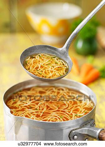 Saucepan and ladle of beef noodle soup with carrots, herbs and stock View Large Photo Image Picture - Saucepan and ladle of beef noodle soup with carrots, herbs and stock. Fotosearch