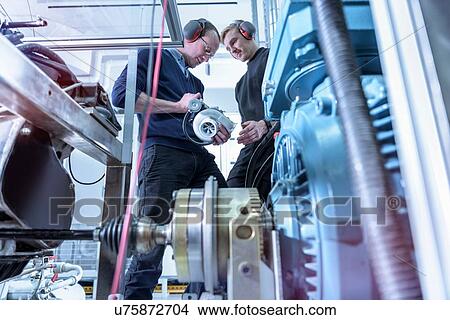 Picture - Scientists in turbo charger automotive research laboratory. Fotosearch