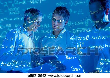 Stock Image - Scientists with projected mathematical data. Fotosearch