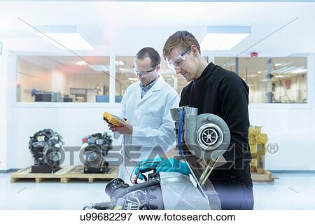 Stock Photo - Scientists working in turbo charger automotive research laboratory. Fotosearch