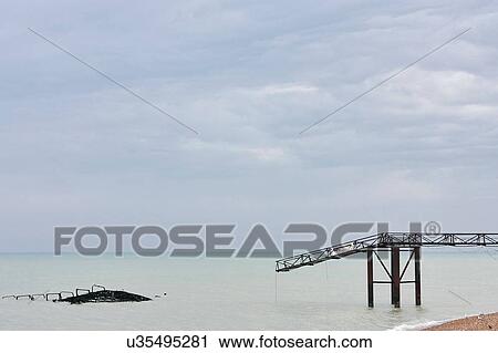 Seascape with remains of old Brighton pier, Brighton, England View Large Photo Image Stock Image - Seascape with remains of old Brighton pier, Brighton, England. Fotosearch