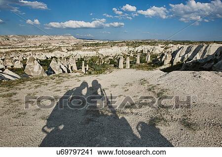 Selfie shadow of tourists on moped in landscape, Cappadocia, Anatolia, Turkey View Large Photo Image Stock Image - Selfie shadow of tourists on moped in landscape, Cappadocia, Anatolia, Turkey. Fotosearch