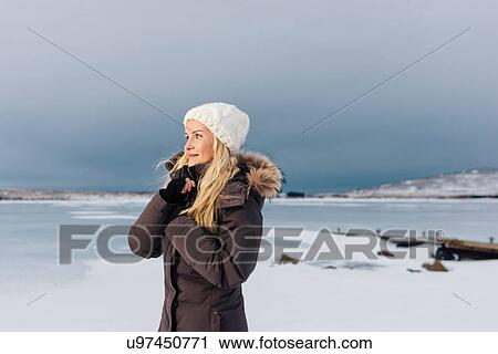 Side view of mid adult woman on frozen landscape looking away smiling View Large Photo Image Stock Image - Side view of mid adult woman on frozen landscape looking away smiling. Fotosearch