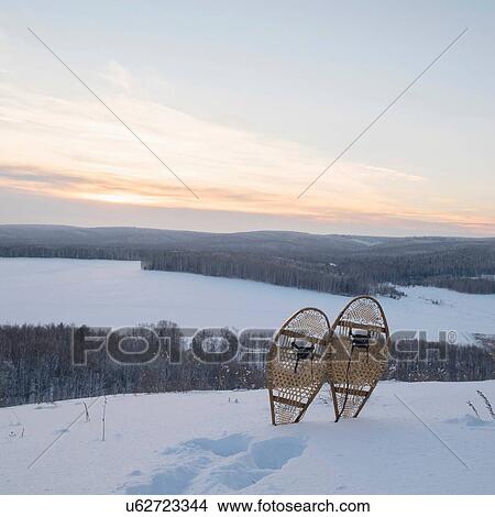Picture - Snow covered landscape with snow shoes and footprints on hill, Ural, Russia. Fotosearch