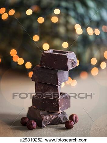Stock Image - Stack of chocolate blocks with hazelnuts. Fotosearch