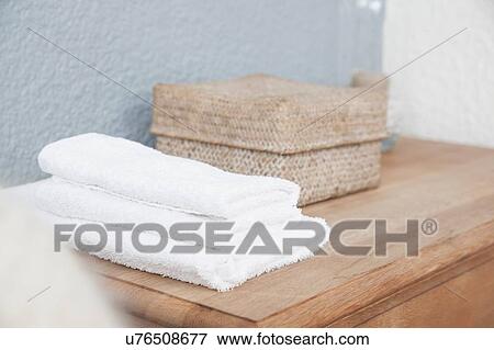 Stack of towels and box on dresser View Large Photo Image Stock Photo - Stack of towels and box on dresser. Fotosearch