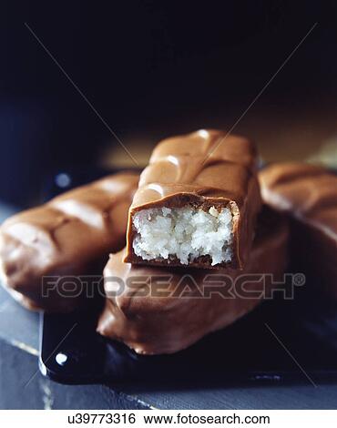 Stacked milk chocolate bars with coconut filling View Large Photo Image Stock Photograph - Stacked milk chocolate bars with coconut filling. Fotosearch