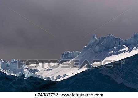 Stock Image - Storm cloud and iceberg at Ilulissat icefjord, Disko Bay, Greenland. Fotosearch