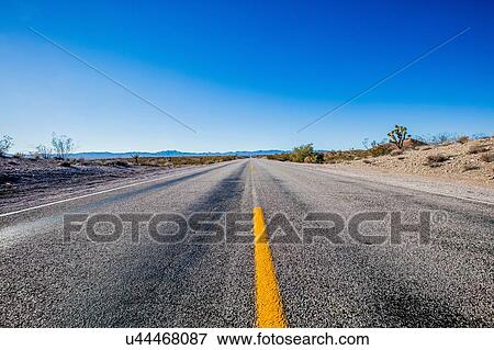 Straight endless road Through Desert photographed near Primm on the Nevada, California and Arizona state border, USA View Large Photo Image Stock Photo - Straight endless road Through Desert photographed near Primm on the Nevada, California and Arizona state border, USA. Fotosearch