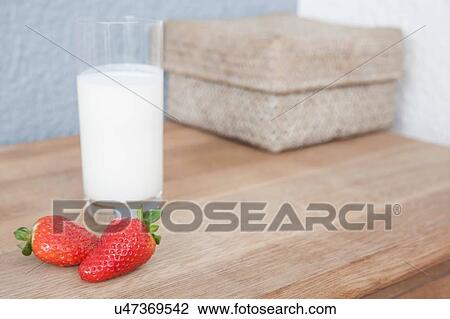Stock Image - Strawberries and a glass of milk. Fotosearch