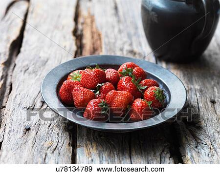 Stock Photo - Strawberries in metal bowl. Fotosearch