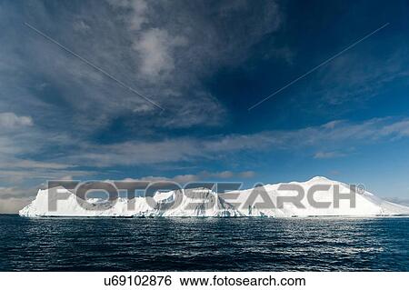 Stock Photograph - Sunlit icebergs at Ilulissat icefjord, Disko Bay, Greenland. Fotosearch