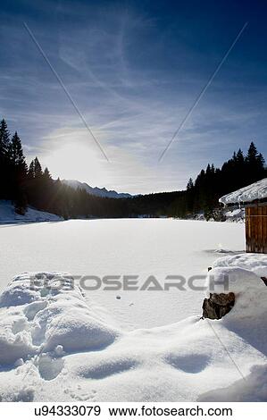 Sunlit landscape with snow covered lake, Berg, Bavaria, Germany View Large Photo Image Stock Photo - Sunlit landscape with snow covered lake, Berg, Bavaria, Germany. Fotosearch