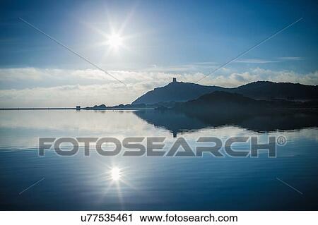 Stock Image - Sunlit seascape and reflection, Villasimius, Sardinia, Italy. Fotosearch