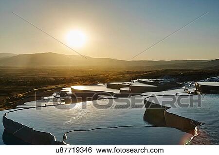 Stock Photograph - Sunset at hot spring terraces, Pamukkale, Anatolia, Turkey. Fotosearch