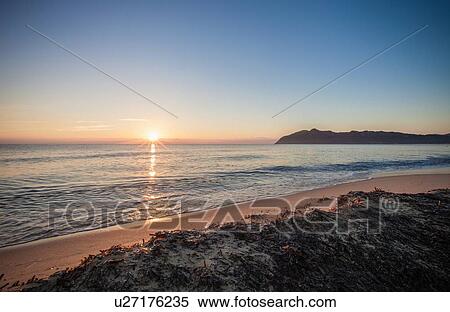 Stock Photography - Sunset over sea, Villasimius, Sardinia, Italy. Fotosearch