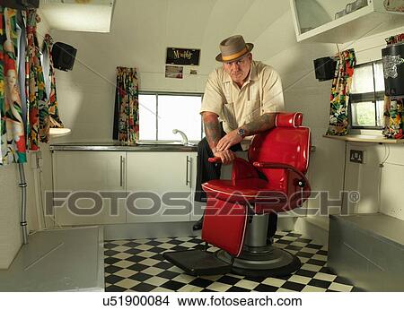 Tattoo artist in mobile tattoo parlour wearing pork pie hat looking at camera View Large Photo Image Picture - Tattoo artist in mobile tattoo parlour wearing pork pie hat looking at camera. Fotosearch