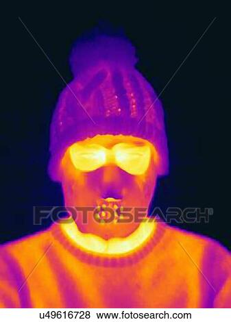 Stock Photo - Thermal image of man wearing threatening mask and knit hat. Fotosearch