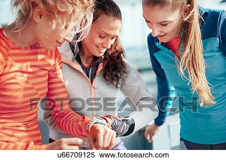 Three female runners checking time on smartwatches View Large Photo Image Stock Photography - Three female runners checking time on smartwatches. Fotosearch