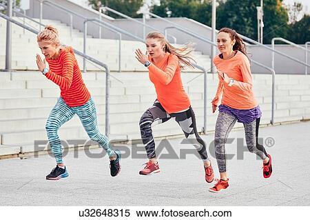 Three female runners racing at city stairway View Large Photo Image Stock Photography - Three female runners racing at city stairway. Fotosearch