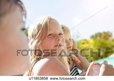 Stock Photo - Three young children, outdoors, looking away. Fotosearch