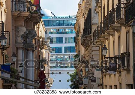 Stock Photo - Tourists looking out from cruise ship onto city street, Trapani, Sicily, Italy. Fotosearch