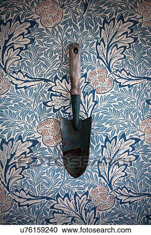 Trowel on floral-patterned background View Large Photo Image Stock Image - Trowel on floral-patterned background. Fotosearch