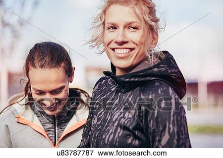Two happy female runners in city View Large Photo Image Stock Photo - Two happy female runners in city. Fotosearch