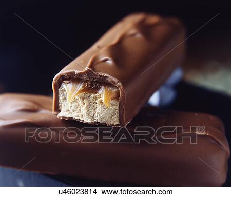 Picture - Two stacked milk chocolate bars with caramel and nougat filling. Fotosearch