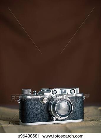 Stock Image - Vintage camera, brown background. Fotosearch