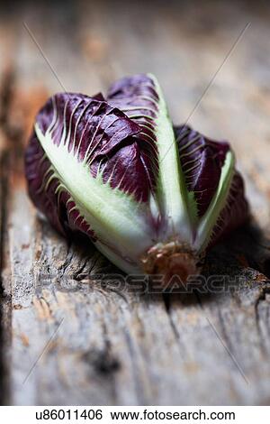 Whole purple lettuce on rough wood surface View Large Photo Image Stock Photograph - Whole purple lettuce on rough wood surface. Fotosearch