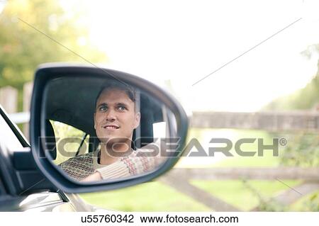 Wing mirror reflection of young man in car parked at rural gate View Large Photo Image Stock Image - Wing mirror reflection of young man in car parked at rural gate. Fotosearch