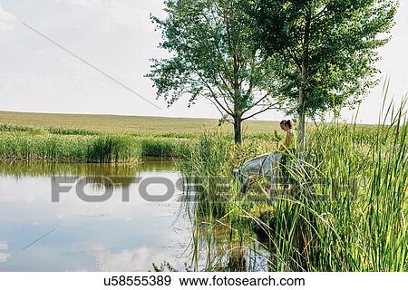 Woman riding grey horse drinking at lake View Large Photo Image Stock Photo - Woman riding grey horse drinking at lake. Fotosearch