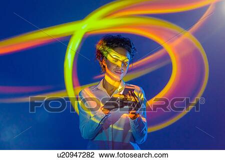 Woman using smart phone with projection View Large Photo Image Stock Image - Woman using smart phone with projection. Fotosearch